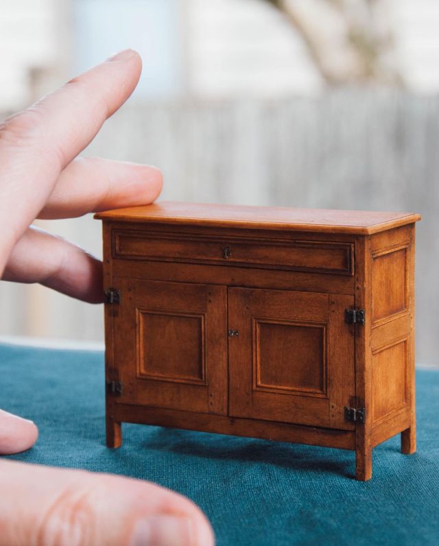 This is my 1/12th scale Virginia Low Cupboard that I made as a prototype for the class I taught for the IGMA Williamsburg Study Program in January, 2023. 

According to the DeWitt Wallace Decorative Arts Museum in Williamsburg, VA, the original full-size cupboard was made in Virginia sometime between 1680-1710. Its cultural roots are unknown, but it might be an interpretation of the French buffet bas, or low cupboard. Widely produced in rural France and areas of transplanted French culture such as the province of Quebec, the waist-high buffet bas typically featured a pair of paneled doors and often included a tier of one or two drawers at the top. French Huguenots, who began immigrating to Virginia in growing numbers at the turn of the eighteenth century, could have introduced the form to the colony. Huguenots settled in a number of Virginia jurisdictions including Surry County on the lower James River, near the place where this cupboard was found.

But the cupboard might also have English roots because a London-inspired, Connecticut-made chest of drawers with doors is in the collection of the Museum of Fine Arts, Boston.

#craiglabenzminiatures